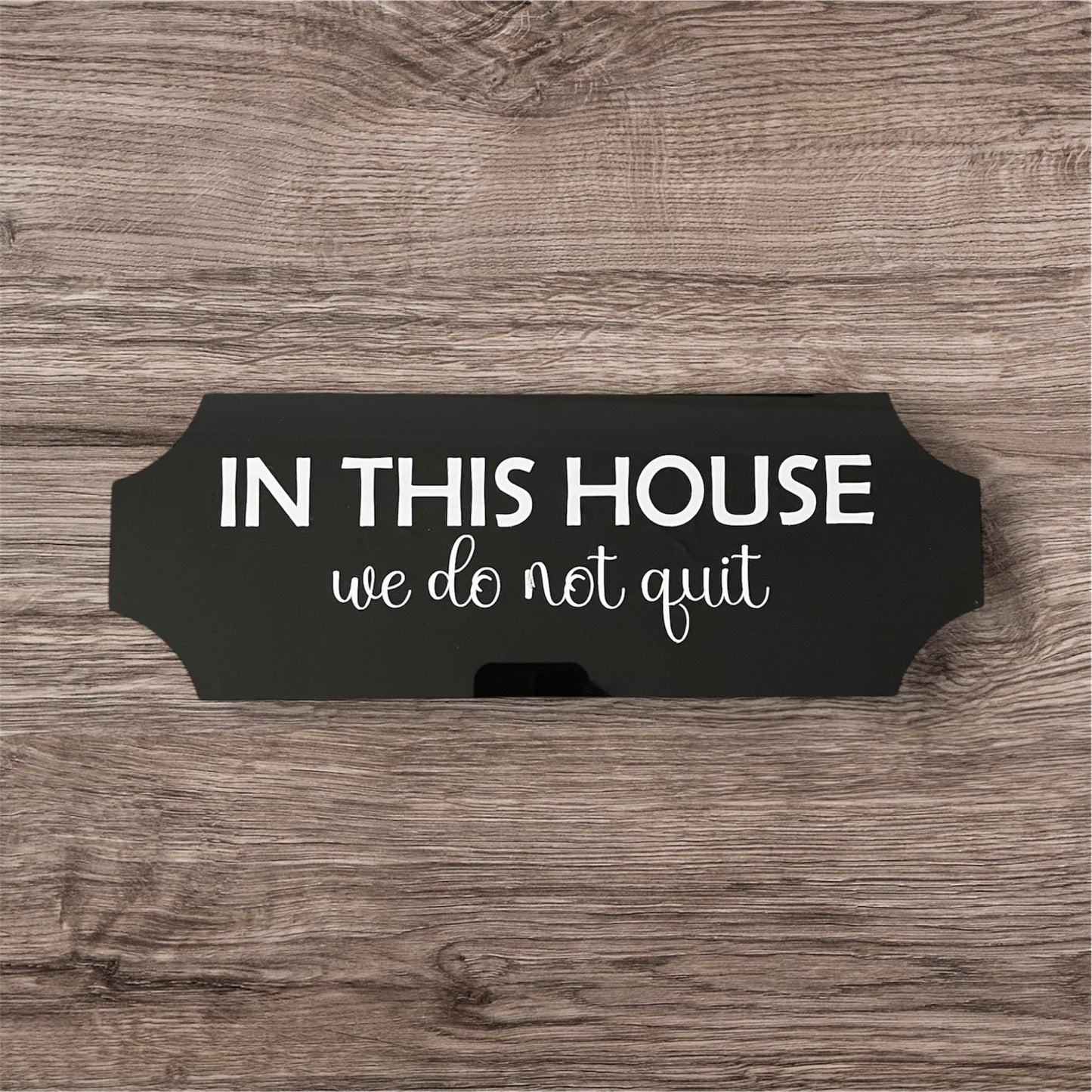 Acrylic sign in this house we do not quit